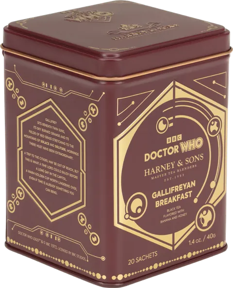 A square metal tin of BBC Doctor Who Harney & Sons Gallifreyan Breakfast tea sachets, featuring a dark reddish-brown and gold design with the Doctor Who logo and Gallifreyan motifs.